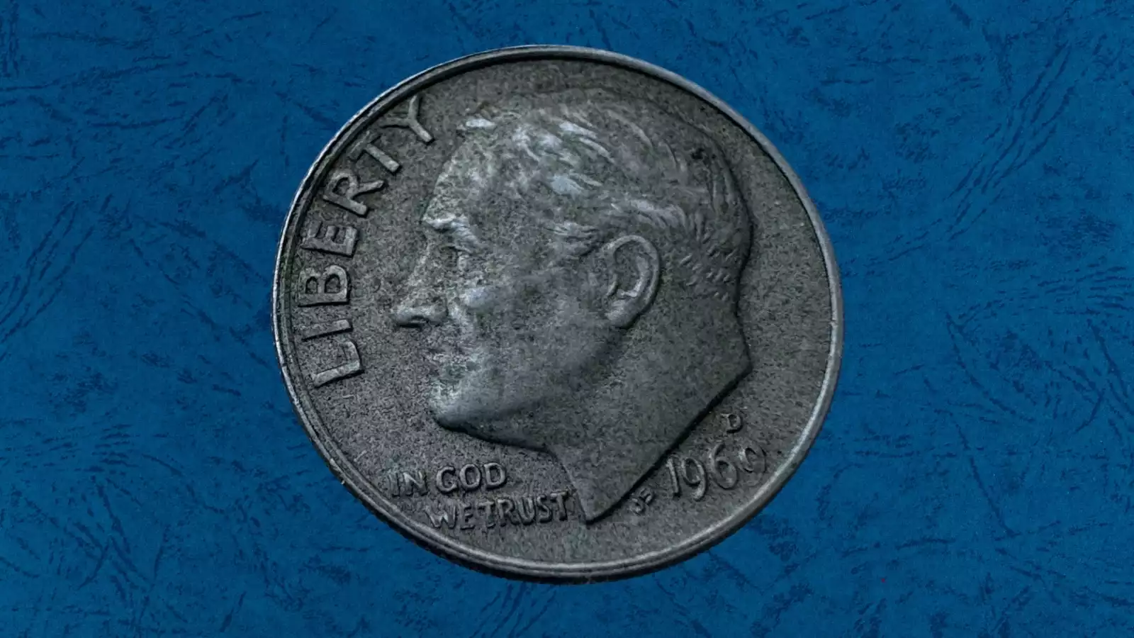 1969 dime missing clad layer error showing exposed reddish-brown copper core on one side